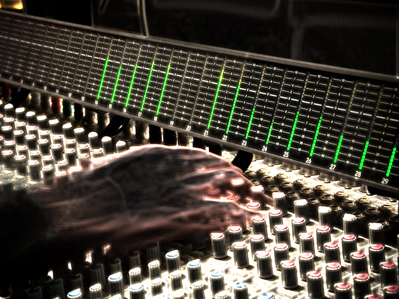 Studio engineer hands on mixing board